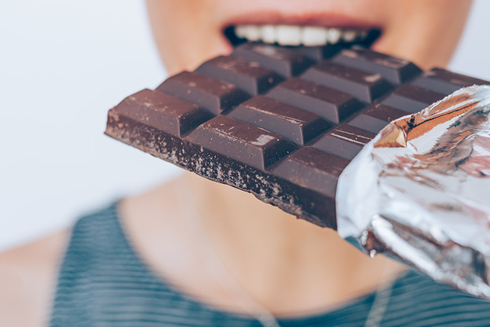 Woman Eating Chocolate Bar