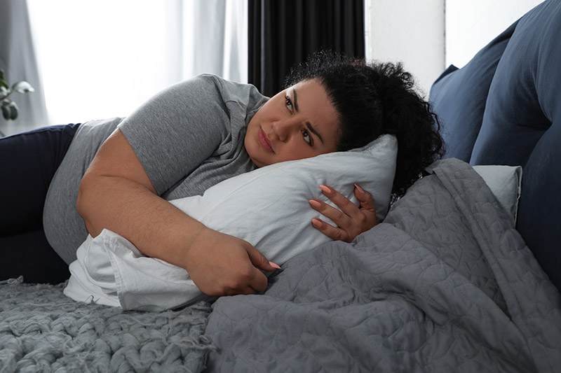 Overweight woman on bed
